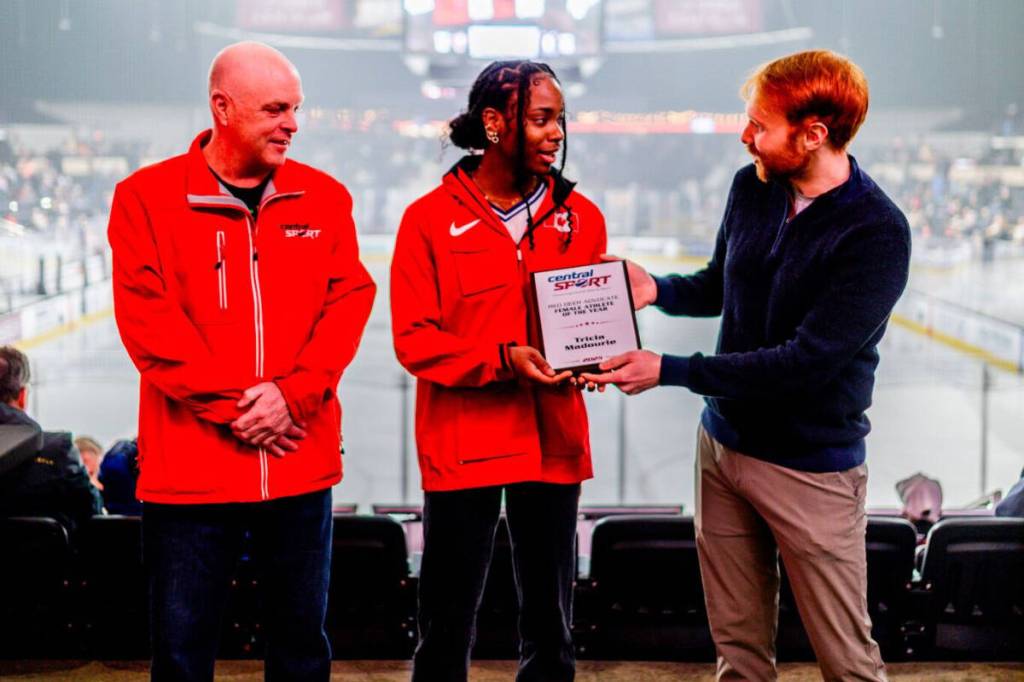 Red Deer Advocate journalist Sean McIntosh (right) presents the Female Athlete of the Year Award to Tricia Madourie while Central Sport CEO Trevor Thomas looks on at the Red Deer Rebels home game against the Calgary Hitmen on Saturday, March 14. (Photo by Taylor Lachance/Red Deer Rebels)